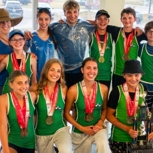 12 young Petrie athletes pose with their medals.