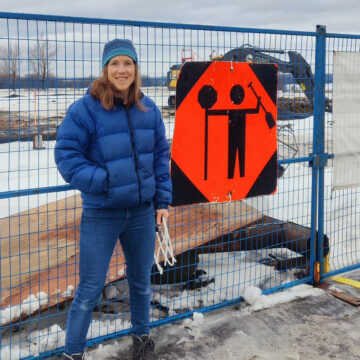 Sarah standing next to a rather humorous construction sign